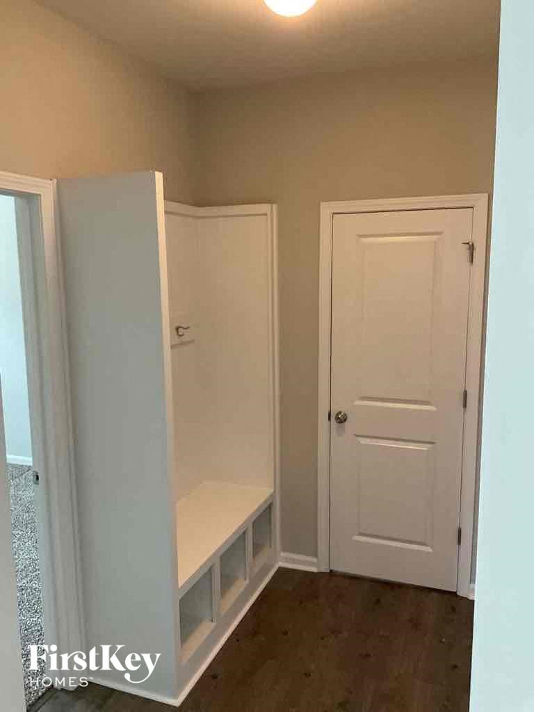 a small room with a white closet and a white door