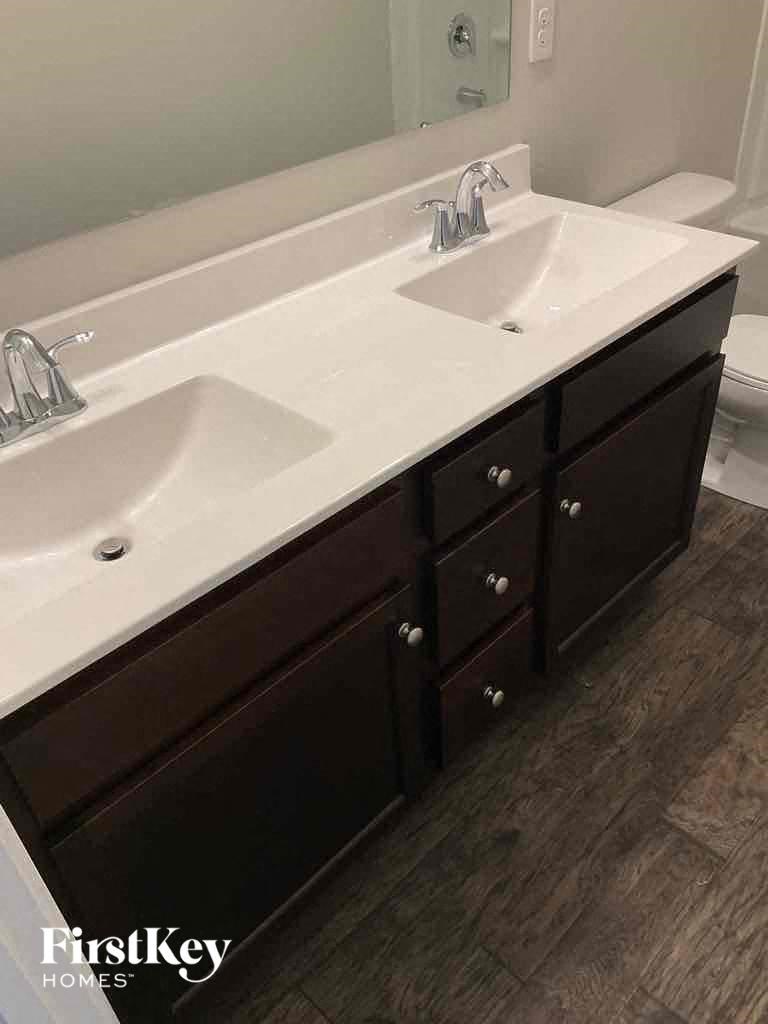 a bathroom with two sinks and a mirror