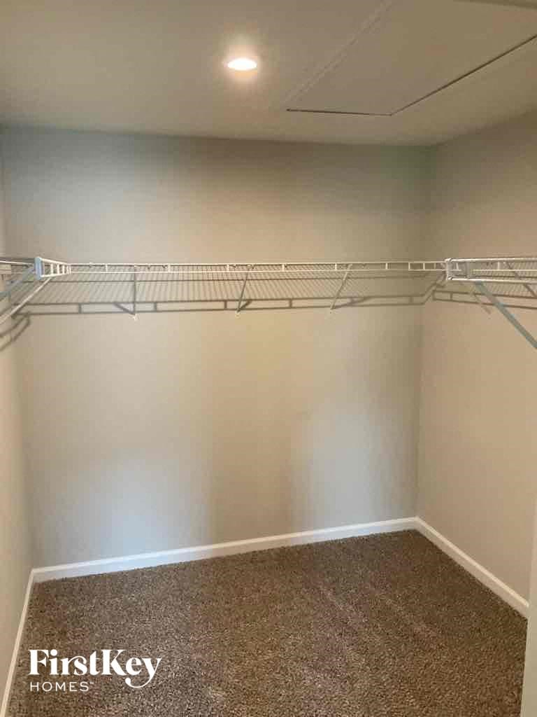 a empty closet in a room with a carpet