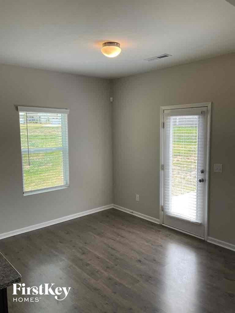 an empty room with a door and a window