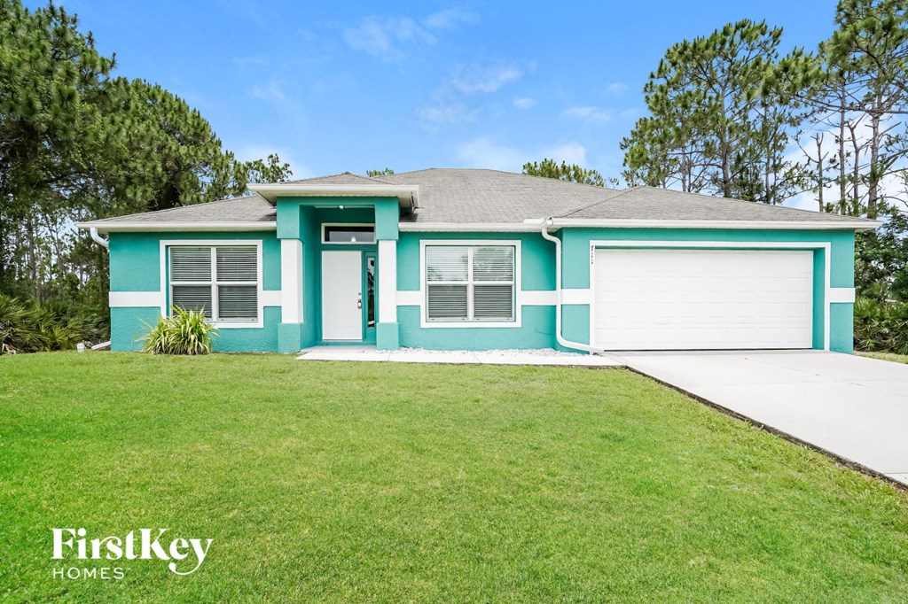 A blue house with a white garage door and a white door.