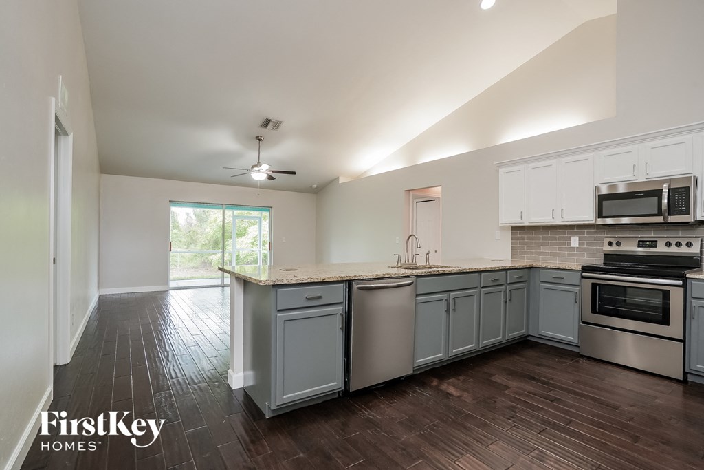 A kitchen with a stove top oven and a microwave.
