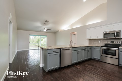 A kitchen with a stove top oven and a microwave.