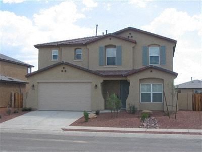 a beige house with a garage and a driveway