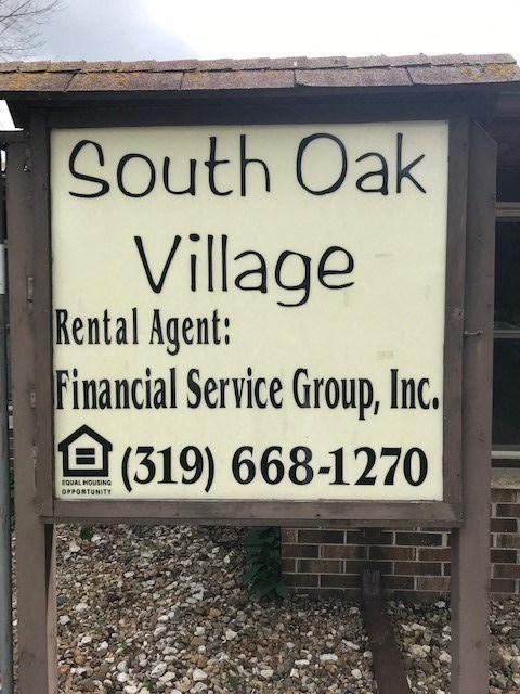 a sign for south oak village is on the side of a building