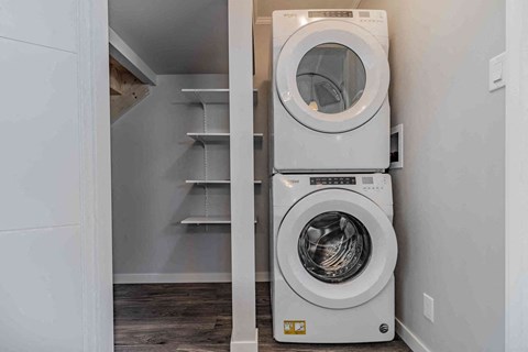 a washer and dryer in a laundry room next to a closet