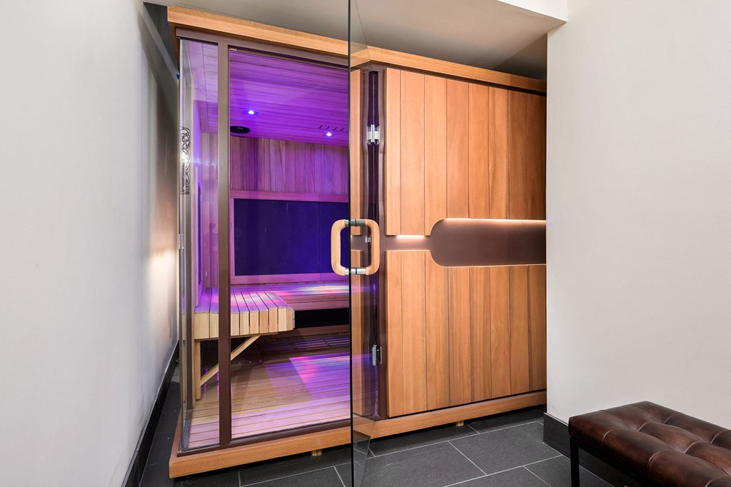a sauna room in a hotel with a wooden door