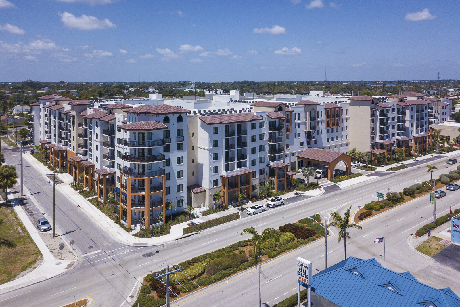 an aerial view of apartment buildings on a city street