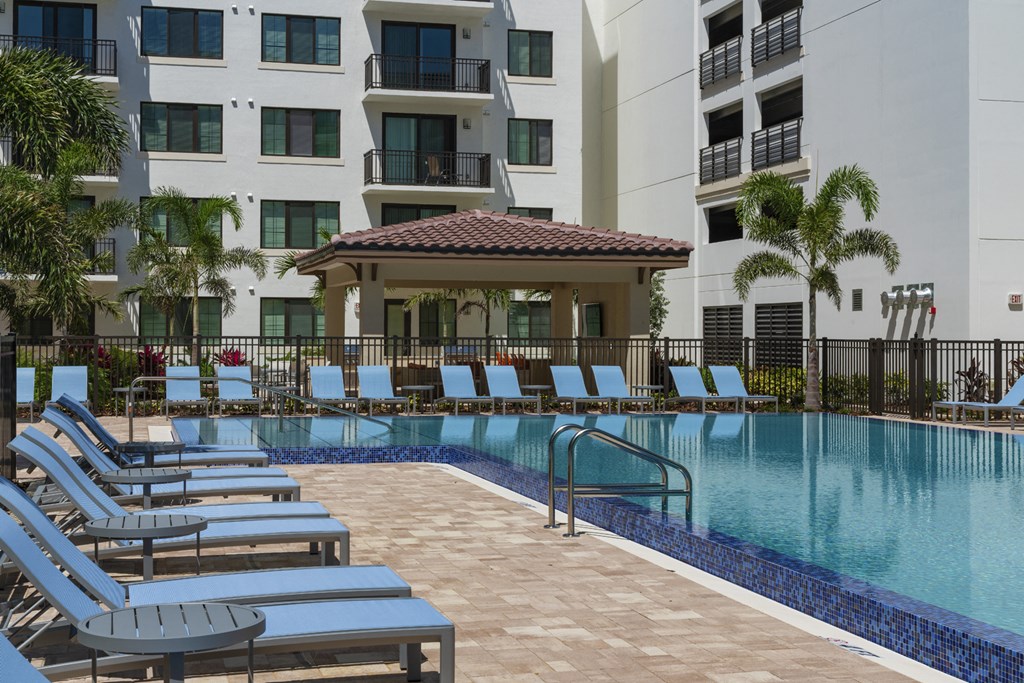 a large swimming pool in front of an apartment building