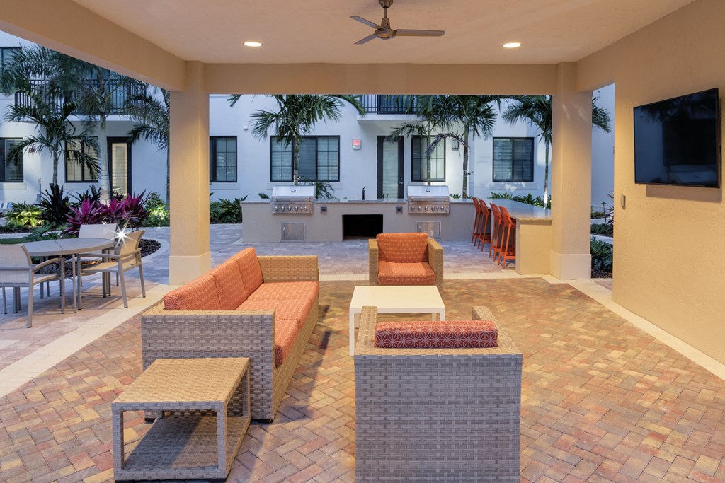 a lounge area with couches and chairs and a bar