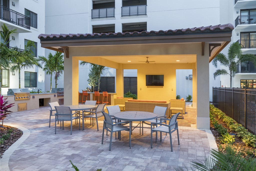 a patio with tables and chairs outside of a building