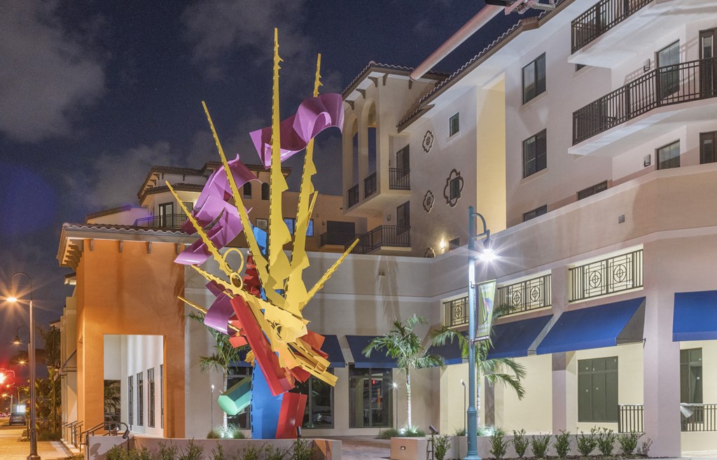 a building with a sculpture in front of it at night