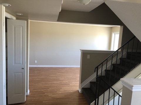 a view of the living room from the bottom of the stairs