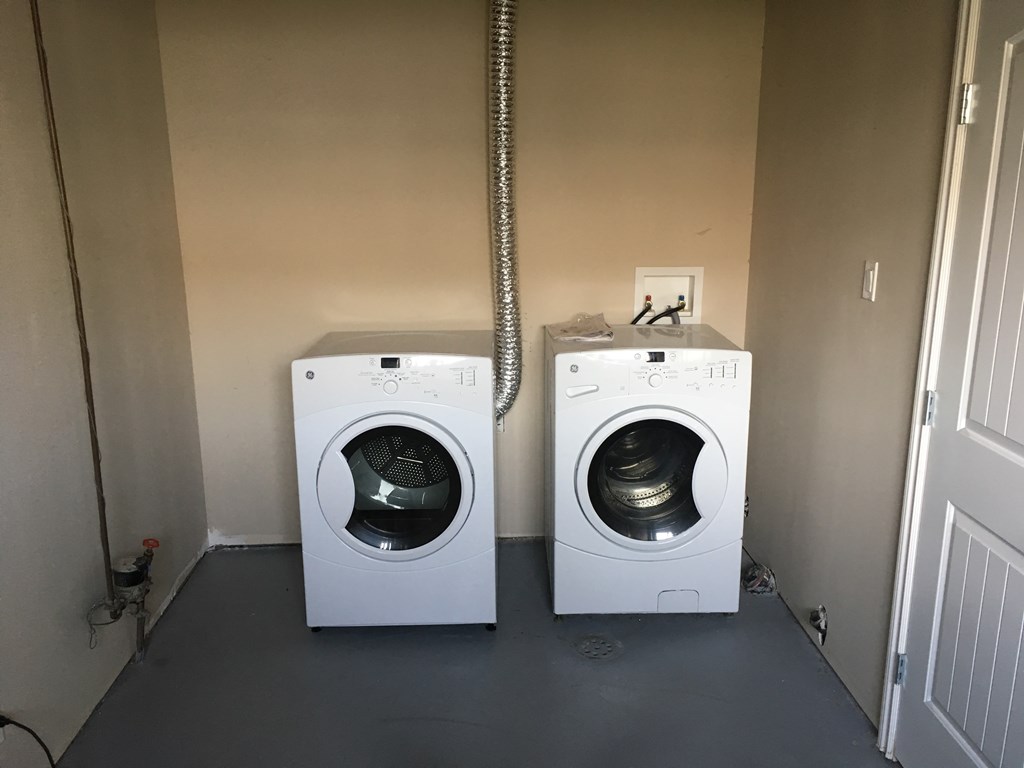 a washing machine and a dryer in a laundry room