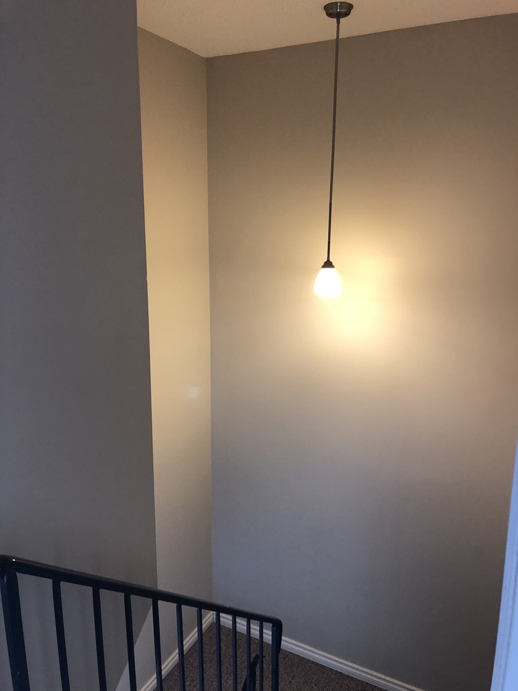 the light is on the wall above the stairs