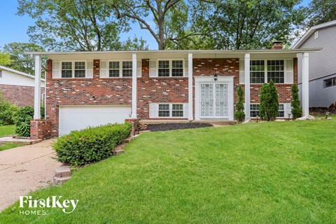 A house with a brick facade and a white garage door.