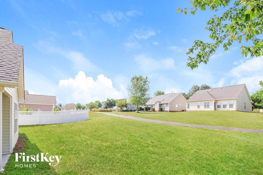a view of a neighborhood with houses and a grass field