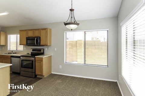 a kitchen with a large window and a stove and a sink