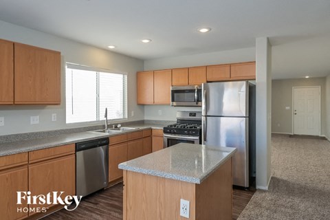 A kitchen with wooden cabinets and stainless steel appliances.