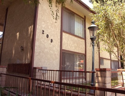 the front of a building with a fence and a street light