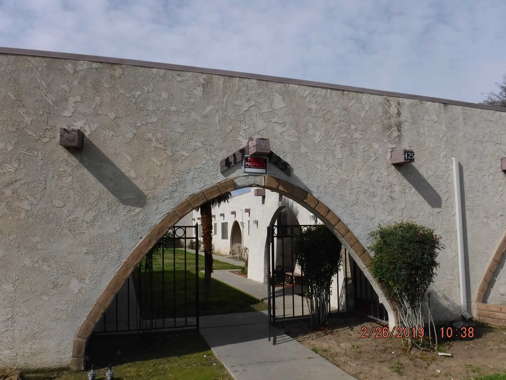 an archway into a building with a gate