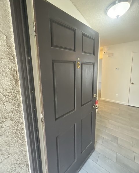 a black door in a room with a tile floor