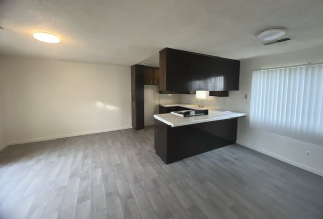 an empty room with a kitchen and a counter top