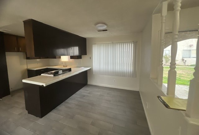an empty kitchen with a sink and a window