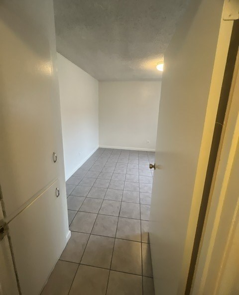 a empty room with a tile floor and a white door