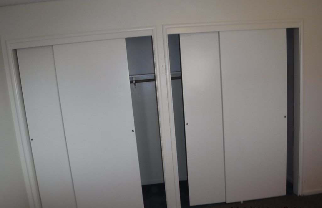 a row of white closet doors in a room