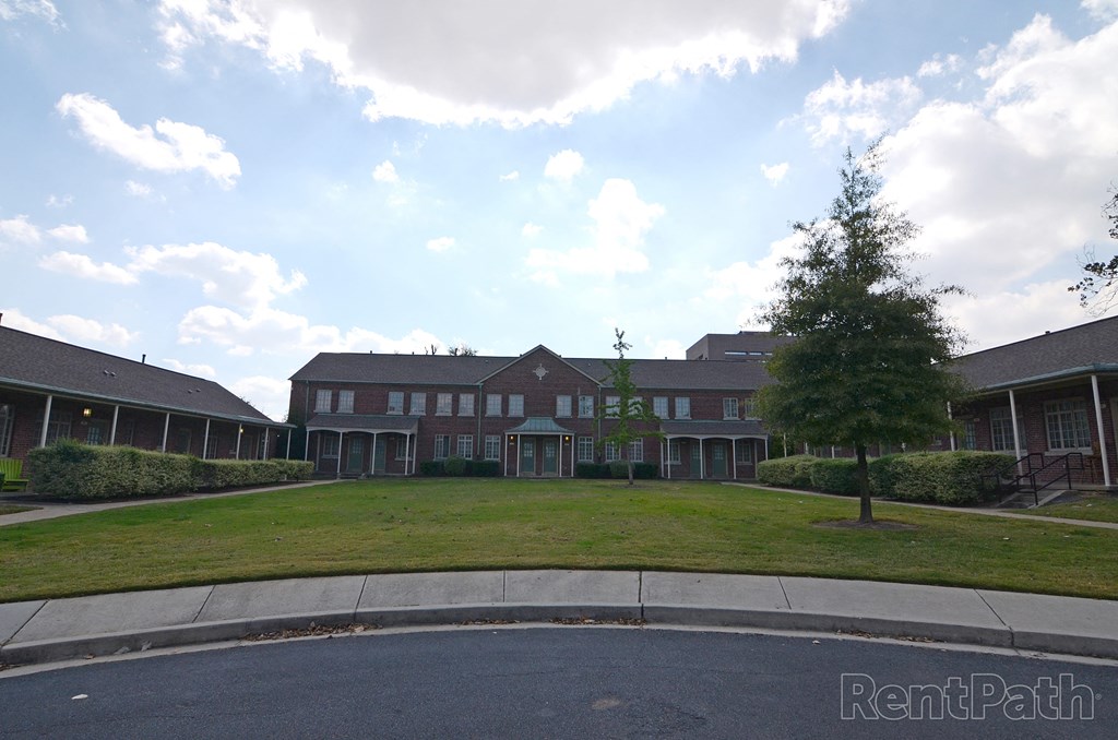 a large building with a lawn in front of it