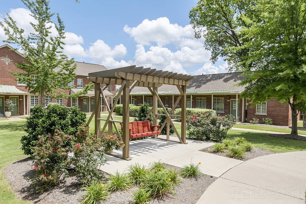 a pavilion with a bench in front of a building