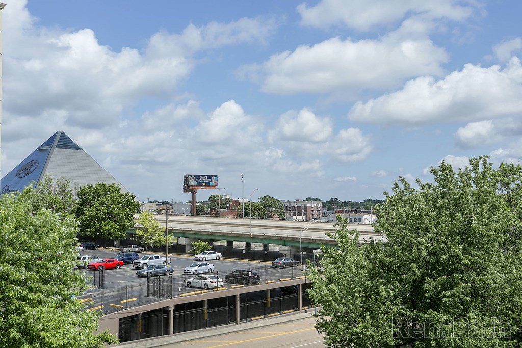an overhead view of the parking lot of the convention center and the highway overpass