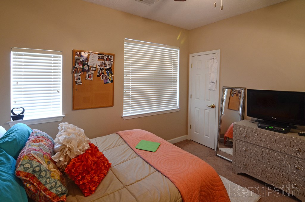 a bedroom with a bed and a tv