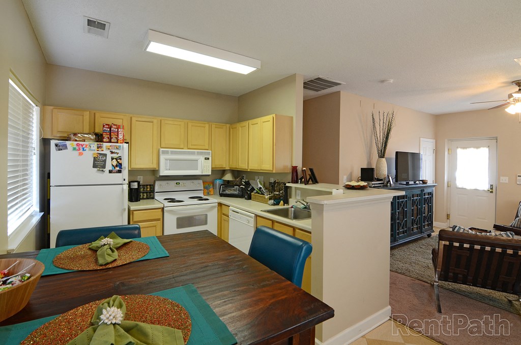 a kitchen and dining room with a table and chairs