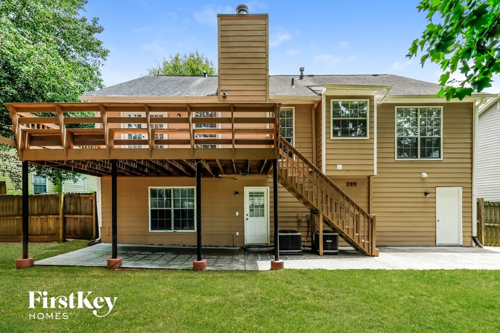A house with a deck and a balcony is for sale by FirstKey Homes.
