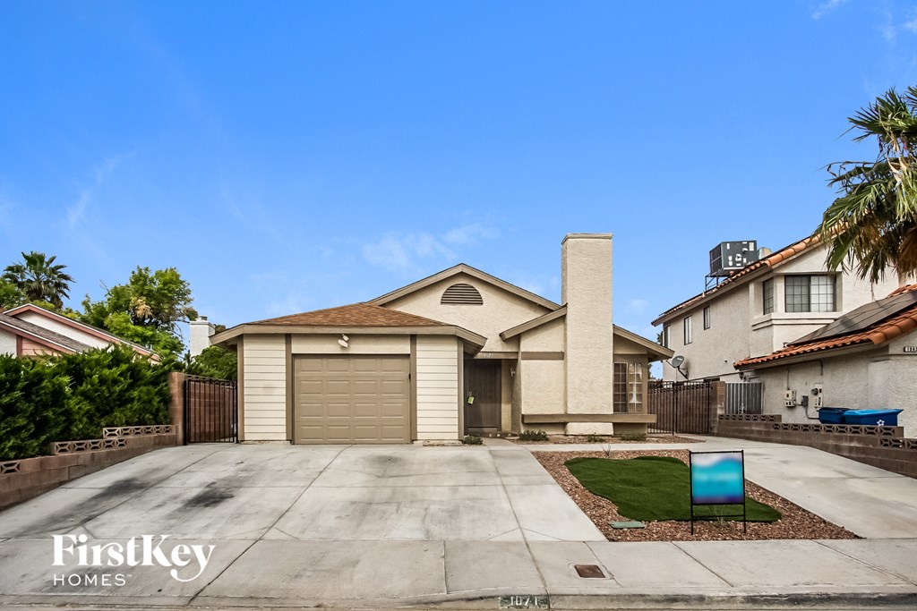 A house with a garage and a driveway is for sale.