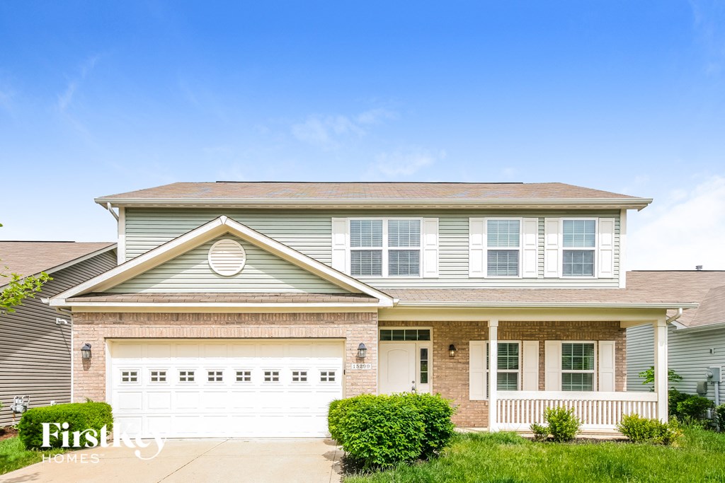a house with a white garage door in front of it