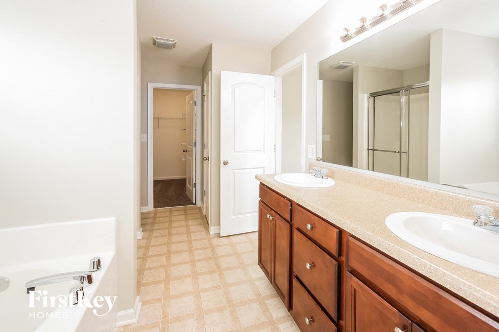 a bathroom with two sinks and a large mirror
