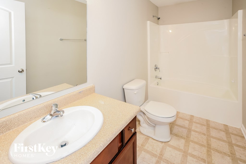 a bathroom with a sink toilet and a shower