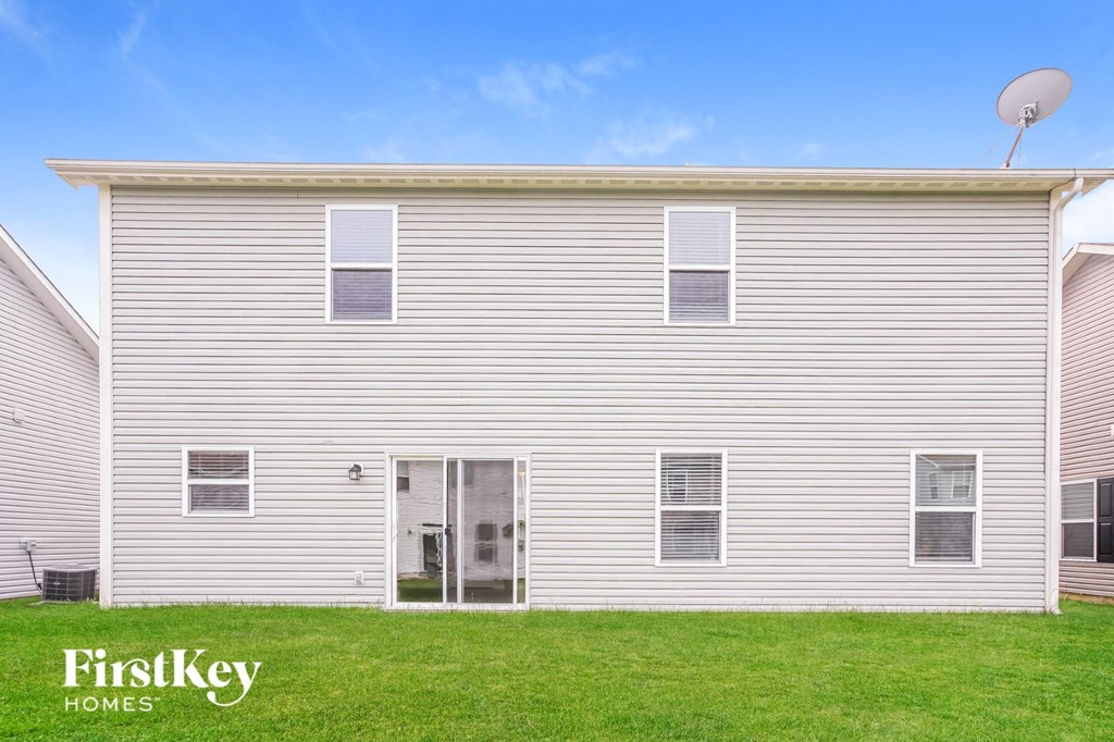 a white house with a lawn in front of it