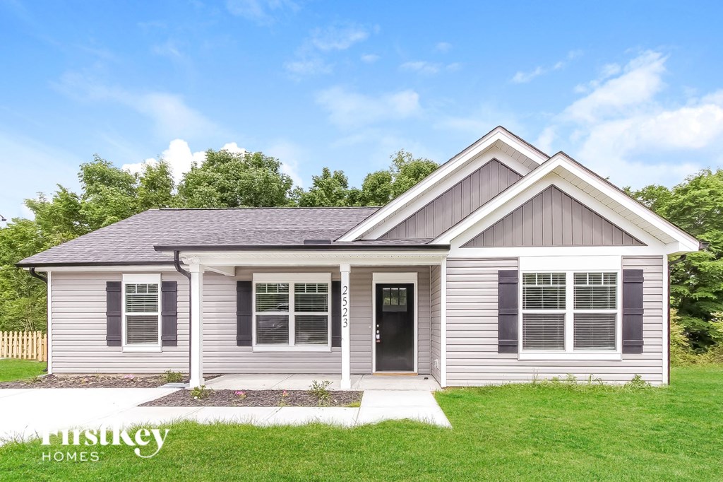 the front view of a white house with gray siding
