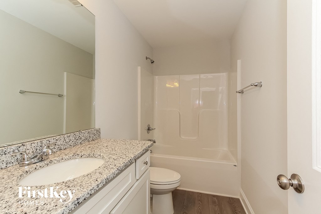 a bathroom with a sink and a toilet and a shower