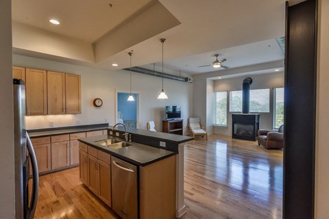 A modern kitchen with wooden cabinets and a black countertop.