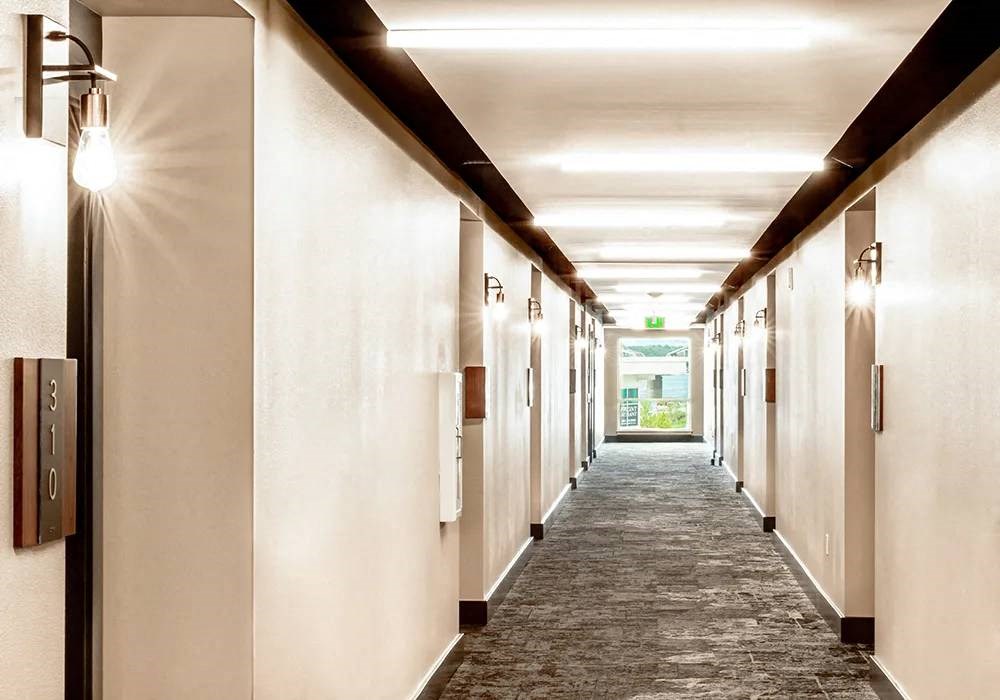 Hallway with LED sconces at each door
