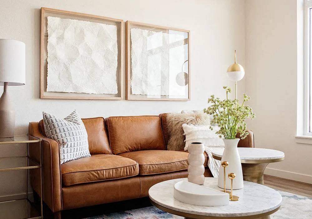 Leather sofa in natural lighting, side table with lamp, and small coffee table