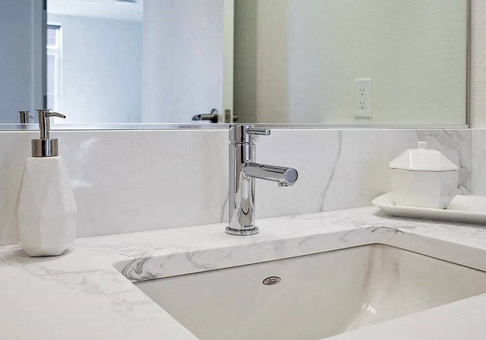 Quartz bathroom sink with brushed nickel faucet
