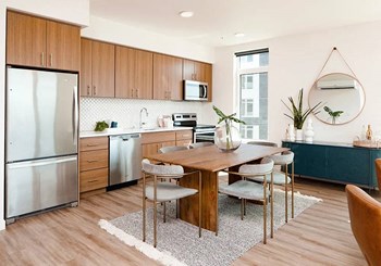 Kitchen with stainless steel refrigerator, dining table, and window - Photo Gallery 32