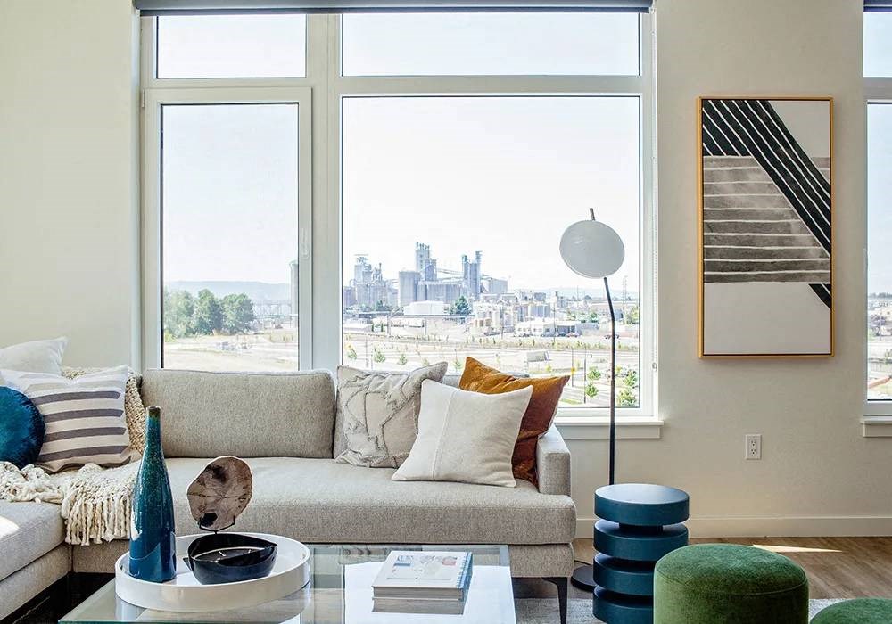 Sectional sofa with large windows facing west in living room
