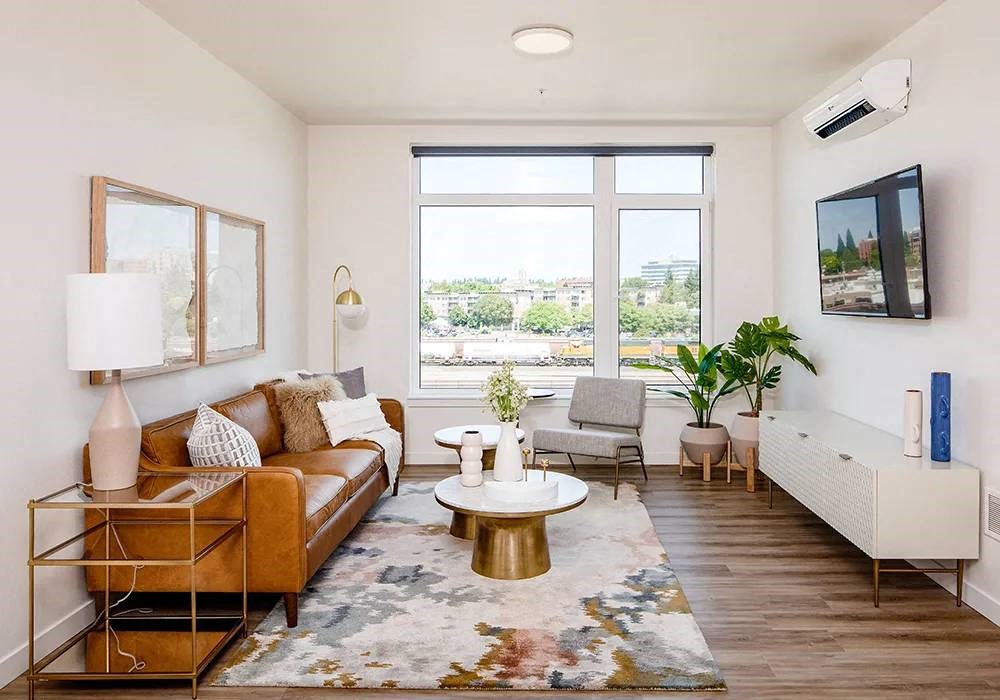 Living room with windows facing north, leather sofa, mounted television